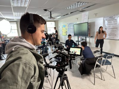 Camera person recording video of students working on math