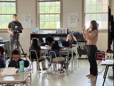 Video recording teacher teaching math lesson